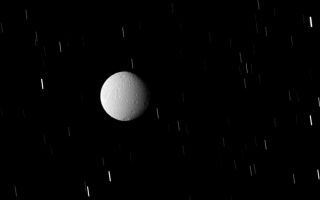 <h1>PIA10508:  Tethys in Eclipse</h1><div class="PIA10508" lang="en" style="width:800px;text-align:left;margin:auto;background-color:#000;padding:10px;max-height:150px;overflow:auto;"><p>Tethys sits within Saturn's shadow, but not in complete darkness. While in eclipse the moon is illuminated by feeble ringshine reflected from the planet's night side and by sunlight scattered through the rings.</p><p>This is a similar observation to <a href="/catalog/PIA10433">PIA10433</a>. Such images provide confirmation of the spacecraft's precise pointing for Cassini's Composite Infrared Spectrometer (CIRS), which measures Tethys' surface temperature as it responds to the sudden darkness of an eclipse.</p><p>Lit terrain seen here is on the Saturn-facing side of Tethys (1,062 kilometers, or 660 miles across). North is up and rotated 12 degrees to the right.</p><p>A long exposure time was required in order to image Tethys while it was in shadow, resulting in the background stars' point-like images being smeared into streaks. Additionally, the image was taken using a compression scheme that reduces the image file size on the spacecraft's data recorder, resulting in the moon's pixilated appearance.</p><p>The image was taken in visible light with the Cassini spacecraft wide-angle camera on Sept. 25, 2008. The view was obtained at a distance of approximately 113,000 kilometers (70,000 miles) from Tethys. Image scale is 7 kilometers (4 miles) per pixel.</p><p>The Cassini-Huygens mission is a cooperative project of NASA, the European Space Agency and the Italian Space Agency. The Jet Propulsion Laboratory, a division of the California Institute of Technology in Pasadena, manages the mission for NASA's Science Mission Directorate, Washington, D.C. The Cassini orbiter and its two onboard cameras were designed, developed and assembled at JPL. The imaging operations center is based at the Space Science Institute in Boulder, Colo.</p><p>For more information about the Cassini-Huygens mission visit <a href="http://saturn.jpl.nasa.gov" class="external free" target="wpext">http://saturn.jpl.nasa.gov/</a>. The Cassini imaging team homepage is at <a href="http://ciclops.org" class="external free" target="wpext">http://ciclops.org</a>.<br /><br /><a href="http://photojournal.jpl.nasa.gov/catalog/PIA10508" onclick="window.open(this.href); return false;" title="Voir l'image 	 PIA10508:  Tethys in Eclipse	  sur le site de la NASA">Voir l'image 	 PIA10508:  Tethys in Eclipse	  sur le site de la NASA.</a></div>