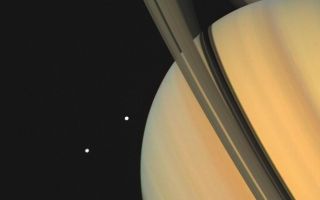 <h1>PIA00024:  Saturn With Tethys and Dione</h1><div class="PIA00024" lang="en" style="width:800px;text-align:left;margin:auto;background-color:#000;padding:10px;max-height:150px;overflow:auto;">Saturn and two of its moons, Tethys (above) and Dione, were photographed by Voyager 1 on November 3, 1980, from 13 million kilometers (8 million miles). The shadows of Saturn's three bright rings and Tethys are cast onto the cloud tops. The limb of the planet can be seen easily through the 3,500-kilometer-wide (2,170 mile) Cassini Division, which separates ring A from ring B. The view through the much narrower Encke Division, near the outer edge of ring A is less clear. Beyond the Encke Division (at left) is the faintest of Saturn's three bright rings, the C-ring or crepe ring, barely visible against the planet. The Voyager Project is managed by the Jet Propulsion Laboratory for NASA.<br /><br /><a href="http://photojournal.jpl.nasa.gov/catalog/PIA00024" onclick="window.open(this.href); return false;" title="Voir l'image 	 PIA00024:  Saturn With Tethys and Dione	  sur le site de la NASA">Voir l'image 	 PIA00024:  Saturn With Tethys and Dione	  sur le site de la NASA.</a></div>