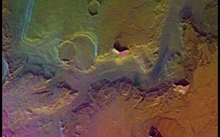 <h1>PIA00153:  Reull Valles (Enhanced Color)</h1><div class="PIA00153" lang="en" style="width:800px;text-align:left;margin:auto;background-color:#000;padding:10px;max-height:150px;overflow:auto;">A conspicuous fretted channel, Reull Valles, which dissects wall deposits of the large Hellas impact basin, trends southeast towards the basin floor. Center of picture is at latitude 42 degrees S., longitude 258 degrees W. Fretted channels are wide, flat-floored channels with steep walls, which may be runoff channels that have been modified and enlarged by masswasting. Many nearby hills and mountains are surrounded by lobate debris aprons, which may have formed by slow creep of rock deposits aided by the presence of near-surface ice. Layering is exposed in the channel and crater walls. The color variations of the surface are very bland in this region; most of the variations seen are due to atmospheric scattering. Viking Orbiter Picture Numbers 126A08 (violet), 126A16 (green), and 126A24 (red) at 157 m/pixel resolution. Picture width is 161 km. North is 112 degrees clockwise from top.<br /><br /><a href="http://photojournal.jpl.nasa.gov/catalog/PIA00153" onclick="window.open(this.href); return false;" title="Voir l'image 	 PIA00153:  Reull Valles (Enhanced Color)	  sur le site de la NASA">Voir l'image 	 PIA00153:  Reull Valles (Enhanced Color)	  sur le site de la NASA.</a></div>