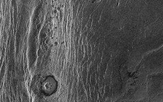 <h1>PIA00250:  Venus - Wanda Crater in Akna Montes</h1><div class="PIA00250" lang="en" style="width:721px;text-align:left;margin:auto;background-color:#000;padding:10px;max-height:150px;overflow:auto;">This Magellan full-resolution images show the northern part of the Akna Montes (mountains) of Venus. The Akna range is a north-south trending ridge belt that forms the western border of the elevated smooth plateau of Lakshmi Planum (plains). The Lakshmi plateau plains are formed by extensive volcanic eruptions and are bounded by mountain chains on all sides. The plains appear to be deformed near the mountains. This suggests that some of the mountain building activity occurred after the plains formed. An impact crater (Official International Astronomical Union name 'Wanda,' mapped first by the Soviet Venera 15/16 mission in 1984 at low resolution) with a diameter of 22 kilometers (14 miles) was formed by the impact of an asteroid in the Akna mountains. The crater has a rugged central peak and a smooth radar-dark floor, probably volcanic material. The crater does not appear to be much deformed by later crustal movement that uplifted the mountains and crumpled the plains. Material from the adjacent mountain ridge to the west, however, appears to have collapsed into the crater. Small pits seen to the north of the crater may be volcanic collapse pits a few kilometers across (1-2 miles). The ridge of the Akna mountains immediately to the west of the crater is 8 kilometers wide (5 miles). The area imaged is approximately 200 kilometers long and 125 kilometers wide (130 by 80 miles). This area is centered at 71.5 degrees north latitude, 324 degrees east longitude. The resolution of the Magellan radar system is 120 meters (400 feet). At this latitude the radar views the surface from an angle of 23 degrees off vertical, creating a perspective as though a viewer were looking at the scene from the right (east) at an angle of 23 degrees above the surface.<br /><br /><a href="http://photojournal.jpl.nasa.gov/catalog/PIA00250" onclick="window.open(this.href); return false;" title="Voir l'image 	 PIA00250:  Venus - Wanda Crater in Akna Montes	  sur le site de la NASA">Voir l'image 	 PIA00250:  Venus - Wanda Crater in Akna Montes	  sur le site de la NASA.</a></div>