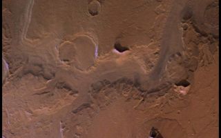 <h1>PIA00322:  Reull Valles in Approximately Natural Color</h1><div class="PIA00322" lang="en" style="width:800px;text-align:left;margin:auto;background-color:#000;padding:10px;max-height:150px;overflow:auto;">Reull Valles, conspicuous southeast-trending fretted channel, dissects wall deposits of the large Hellas impact basin. Center of picture is at latitude 42 degrees S. longitude 258 degrees. Fretted channels are wide, flat-floored channels with steep walls, which may be runoff channels that have been modified and enlarged by mass wasting. Many nearby hills and mountains are surrounded by lobate debris aprons, which may have formed by slow creep of rock deposits aided by the presence of near-surface ice. Layering is exposed in the channel and crater walls. The color variations of the surface are very bland in this region; most of the variations seen in the enhanced-color version (PIA00153) are due to atmospheric scattering. Viking Orbiter Picture Numbers 126A08 (violet), 126A16 (green), and 126A24 (red) at 157 m/pixel resolution. Picture width is 161 km. North is 112 degrees clockwise from top.<br /><br /><a href="http://photojournal.jpl.nasa.gov/catalog/PIA00322" onclick="window.open(this.href); return false;" title="Voir l'image 	 PIA00322:  Reull Valles in Approximately Natural Color	  sur le site de la NASA">Voir l'image 	 PIA00322:  Reull Valles in Approximately Natural Color	  sur le site de la NASA.</a></div>