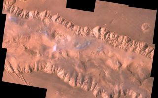<h1>PIA00424:  East Candor Chasma</h1><div class="PIA00424" lang="en" style="width:800px;text-align:left;margin:auto;background-color:#000;padding:10px;max-height:150px;overflow:auto;"><p>During its examination of Mars, the Viking 1 spacecraft returned images of Valles Marineris, a huge canyon system 5,000 km long, up to 240 km wide, and 6.5 km deep, whose connected chasma or valleys may have formed from a combination of erosional collapse and structural activity. The view shows east Candor Chasma, one of the connected valleys of Valles Marineris; north toward top of frame; for scale, the impact crater in upper right corner is 15 km (9 miles) wide. The image, centered at latitude 7.5 degrees S., longitude 67.5 degrees, is a composite of Viking 1 Orbiter high-resolution (about 80 m/pixel or picture element) images in black and white and low-resolution (about 250 m/pixel) images in color. The Viking 1 craft landed on Mars in July of 1976.</p><p>East Candor Chasma occupies the eastern part of the large west-northwest-trending trough of Candor Chasma. This section is about 150 km wide. East Candor Chasma is bordered on the north and south by walled cliffs, most likely faults. The walls may have been dissected by landslides forming reentrants; one area on the north wall shows what appears to be landslide debris. Both walls show spur-and-gully morphology and smooth sections. In the lower part of the image northwest-trending, linear depressions on the plateau are younger graben or fault valleys that cut the south wall.</p><p>Material central to the chasma shows layering in places and has been locally eroded by the wind to form flutes and ridges. These interior layered deposits have curvilinear reentrants carved into them, and in one locale a lobe flows away from the top of the interior deposit. The lobe may be mass-wasting deposits due to collapse of older interior deposits (Lucchitta, 1996, LPSC XXVII abs., p. 779- 780); this controversial idea requires that the older layered deposits were saturated with ice, perhaps from former lakes, and that young volcanism and/or tectonism melted the ice and made the material flow.<br /><br /><a href="http://photojournal.jpl.nasa.gov/catalog/PIA00424" onclick="window.open(this.href); return false;" title="Voir l'image 	 PIA00424:  East Candor Chasma	  sur le site de la NASA">Voir l'image 	 PIA00424:  East Candor Chasma	  sur le site de la NASA.</a></div>