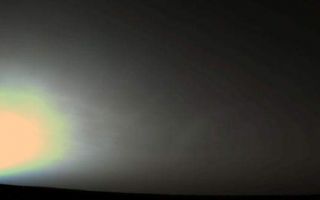 <h1>PIA00576:  Martian Sunrise at Utopia Planitia</h1><div class="PIA00576" lang="en" style="width:745px;text-align:left;margin:auto;background-color:#000;padding:10px;max-height:150px;overflow:auto;">A Martian sunrise was captured in this Viking 2 Lander picture taken June 14, 1978, at the spacecraft's Utopia Planitia landing site. The data composing this image were acquired just as the Sun peaked over the horizon on the Lander's 631st sol (Martian solar day). Pictures taken at dawn (or dusk) are quite dark except where the sky is brightened above the Sun's position. The glow in the sky results as light from the Sun is scattered and preferentially absorbed by tiny particles of dust and ice in the atmosphere. When the Viking cameras are calibrated for darker scenes, the "sky glow" tends to saturate their sensitivity and produce the bright regions seen here. The "banding" and color separation effects are also artifacts, rather than real features, and are introduced because the cameras are not able to record continuous gradations of light. The cameras must represent such gradations in steps (bands) of brightness and color, and the process sometimes produces some "false" colors within the bands. The scattering of light closest to the Sun's position tends to enhance blue wavelengths. The narrowing sky glow nearer the horizon above the Sun's position occurs as a result of light extinction. At that elevation, the optical path of sunlight through the atmosphere is at its longest penetration angle, and a substantial portion of the light is simply prevented from reaching the cameras by the dust, ice particles and other material in its way.<p>NASA's Langley Research Center was the primary and extended mission manager; JPL assumed management for continued mission operations.<br /><br /><a href="http://photojournal.jpl.nasa.gov/catalog/PIA00576" onclick="window.open(this.href); return false;" title="Voir l'image 	 PIA00576:  Martian Sunrise at Utopia Planitia	  sur le site de la NASA">Voir l'image 	 PIA00576:  Martian Sunrise at Utopia Planitia	  sur le site de la NASA.</a></div>
