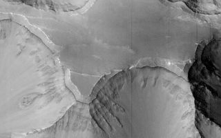 <h1>PIA01168:  Layers within the Valles Marineris: Clues to the Ancient Crust of Mars - High Resolution Image</h1><div class="PIA01168" lang="en" style="width:684px;text-align:left;margin:auto;background-color:#000;padding:10px;max-height:150px;overflow:auto;">This high resolution picture of the Martian surface was obtained in the early evening of January 1, 1998 by the Mars Orbiter Camera (MOC), shortly after the Mars Global Surveyor spacecraft began it's 80th orbit. Seen in this view are a plateau and surrounding steep slopes within the Valles Marineris, the large system of canyons that stretches 4000 km (2500 mi) along the equator of Mars. The image covers a tiny fraction of the canyons at very high resolution: it extends only 9.8 km by 17.3 km (6.1 mi by 10.7 mi) but captures features as small as 6 m (20 ft) across. The highest terrain in the image is the relatively smooth plateau near the center. Slopes descend to the north and south (upper and lower part of image, respectively) in broad, debris-filled gullies with intervening rocky spurs. Multiple rock layers, varying from a few to a few tens of meters thick, are visible in the steep slopes on the spurs and gullies. Layered rocks on Earth form from sedimentary processes (such as those that formed the layered rocks now seen in Arizona's Grand Canyon) and volcanic processes (such as layering seen in the Waimea Canyon on the island of Kauai). Both origins are possible for the Martian layered rocks seen in this image. In either case, the total thickness of the layered rocks seen in this image implies a complex and extremely active early history for geologic processes on Mars.<p>Malin Space Science Systems (MSSS) and the California Institute of Technology built the MOC using spare hardware from the Mars Observer mission. MSSS operates the camera from its facilities in San Diego, CA. The Jet Propulsion Laboratory's Mars Surveyor Operations Project operates the Mars Global Surveyor spacecraft with its industrial partner, Lockheed Martin Astronautics, from facilities in Pasadena, CA and Denver, CO.<br /><br /><a href="http://photojournal.jpl.nasa.gov/catalog/PIA01168" onclick="window.open(this.href); return false;" title="Voir l'image 	 PIA01168:  Layers within the Valles Marineris: Clues to the Ancient Crust of Mars - High Resolution Image	  sur le site de la NASA">Voir l'image 	 PIA01168:  Layers within the Valles Marineris: Clues to the Ancient Crust of Mars - High Resolution Image	  sur le site de la NASA.</a></div>