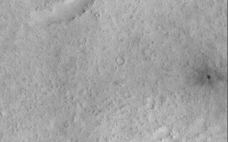 <h1>PIA01434:  Small, Fresh Impact Crater With Dark Ejecta</h1><div class="PIA01434" lang="en" style="width:700px;text-align:left;margin:auto;background-color:#000;padding:10px;max-height:150px;overflow:auto;">This picture is one of the first images obtained by MOC following the May 1998 period of solar conjunction. During solar conjunction, MOC and the other instruments on Mars Global Surveyor were off while Mars was behind the Sun, relative to Earth. The spacecraft could not communicate with Earth during this time. After solar conjunction, Mars Global Surveyor entered the SPO-2 observing phase-- the second Science Phasing Orbit period.<p>Orbit 338 was the first orbit on which MOC obtained pictures following solar conjunction. This orbit executed on June 1, 1998. The picture above shows a 12.3 meters (40 feet) per pixel view of the floor of an ancient, eroded, 47 kilometer (29 miles) wide impact crater.<p>The most striking feature in this image is the small crater with dark ejecta on the far right side. This crater, formed by a meteor impact, is only about 38 meters (125 feet) across. The blast that formed the crater sent out ejecta in a radial pattern around the impact site. The ejecta pattern may be dark because subsurface dark material was thrown out by the impact or because the disturbed ground reflects less light. By martian standards, this crater is quite young--so young that fine, bright dust that has not yet covered it up. While interpreted to be geologically young, the crater is definitely more than 18 years old, because it is visible as a small, dark spot in the Viking context image taken in 1980. Also visible in this image are some small wind-blown dunes and many small mesas and buttes that probably formed by erosion.<p>The MOC image 33806 subframe is located at 9.94°N, 311.23°W, in the eastern Arabia Terra region of Mars. The picture was taken at 8:15 a.m. PDT on June 1, 1998.<p><p>Malin Space Science Systems and the California Institute of Technology built the MOC using spare hardware from the Mars Observer mission. MSSS operates the camera from its facilities in San Diego, CA. The Jet Propulsion Laboratory's Mars Surveyor Operations Project operates the Mars Global Surveyor spacecraft with its industrial partner, Lockheed Martin Astronautics, from facilities in Pasadena, CA and Denver, CO.<br /><br /><a href="http://photojournal.jpl.nasa.gov/catalog/PIA01434" onclick="window.open(this.href); return false;" title="Voir l'image 	 PIA01434:  Small, Fresh Impact Crater With Dark Ejecta	  sur le site de la NASA">Voir l'image 	 PIA01434:  Small, Fresh Impact Crater With Dark Ejecta	  sur le site de la NASA.</a></div>
