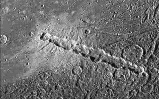 <h1>PIA01610:  Anatomy of a Torn Comet</h1><div class="PIA01610" lang="en" style="width:392px;text-align:left;margin:auto;background-color:#000;padding:10px;max-height:150px;overflow:auto;"><p>View of a chain of craters named Enki Catena on Jupiter's moon, Ganymede. This chain of 13 craters probably formed by a comet which was pulled into pieces by Jupiter's gravity as it passed too close to the planet. Soon after this breakup, the 13 fragments crashed onto Ganymede in rapid succession. The Enki craters formed across the sharp boundary between areas of bright terrain and dark terrain, delimited by a thin trough running diagonally across the center of this image. The ejecta deposit surrounding the craters appears very bright on the bright terrain. Even though all the craters formed nearly simultaneously, it is difficult to discern any ejecta deposit on the dark terrain. This may be because the impacts excavated and mixed dark material into the ejecta and the resulting mix is not apparent against the dark background.</p><p>North is to the bottom of the picture and the sun illuminates the surface from the left. The image, centered at 39 degrees latitude and 13 degrees longitude, covers an area approximately 214 by 217 kilometers. The resolution is 545 meters per picture element. The image was taken on April 5, 1997 at 6 hours, 12 minutes, 22 seconds Universal Time at a range of 27282 kilometers by the Solid State Imaging (SSI) system on NASA's Galileo spacecraft.</p><p>The Jet Propulsion Laboratory, Pasadena, CA manages the Galileo mission for NASA's Office of Space Science, Washington, DC.</p><p>This image and other images and data received from Galileo are posted on the World Wide Web, on the Galileo mission home page at URL <a href="http://galileo.jpl.nasa.gov">http:// galileo.jpl.nasa.gov</a>. Background information and educational context for the images can be found at <a href="http://www2.jpl.nasa.gov/galileo/sepo/" target="_blank">http://www.jpl.nasa.gov/galileo/sepo</a>.<br /><br /><a href="http://photojournal.jpl.nasa.gov/catalog/PIA01610" onclick="window.open(this.href); return false;" title="Voir l'image 	 PIA01610:  Anatomy of a Torn Comet	  sur le site de la NASA">Voir l'image 	 PIA01610:  Anatomy of a Torn Comet	  sur le site de la NASA.</a></div>