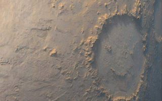 <h1>PIA01676:  "Happy Face" Crater Greets MGS at the Start of the Mapping</h1><div class="PIA01676" lang="en" style="width:525px;text-align:left;margin:auto;background-color:#000;padding:10px;max-height:150px;overflow:auto;"><p>The story of the Mars Orbiter Camera (MOC) onboard the Mars Global Surveyor(MGS) spacecraft began with a proposal to NASA in 1985. The first MOC flew on Mars Observer, a spacecraft that was lost before it reached the red planet in 1993. Now, after 14 years of effort, a MOC has finally been placed in the desired mapping orbit. The MOC team's happiness is perhaps best expressed by the planet Mars itself. On the first day of the Mapping Phase of the MGS mission--during the second week of March 1999--MOC was greeted with this view of "Happy Face Crater" (center right) smiling back at the camera from its location on the east side of Argyre Planitia. This crater is officially known as Galle Crater, and it is about 215 kilometers (134 miles) across. The picture was taken by the MOC's red and blue wide angle cameras. The bluish-white tone is caused by wintertime frost. Illumination is from the upper left. For more information and Viking Orbiter views of "Happy Face Crater," see <a href="http://www.msss.com/education/happy_face/happy_face.html">http://www.msss.com/education/happy_face/happy_face.html</a>.</p><p>Malin Space Science Systems and the California Institute of Technology built the MOC using spare hardware from the Mars Observer mission. MSSS operates the camera from its facilities in San Diego, CA. The Jet Propulsion Laboratory's Mars Surveyor Operations Project operates the Mars Global Surveyor spacecraft with its industrial partner, Lockheed Martin Astronautics, from facilities in Pasadena, CA and Denver, CO.</p><br /><br /><a href="http://photojournal.jpl.nasa.gov/catalog/PIA01676" onclick="window.open(this.href); return false;" title="Voir l'image 	 PIA01676:  "Happy Face" Crater Greets MGS at the Start of the Mapping	  sur le site de la NASA">Voir l'image 	 PIA01676:  "Happy Face" Crater Greets MGS at the Start of the Mapping	  sur le site de la NASA.</a></div>