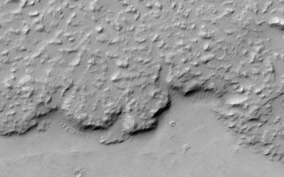 <h1>PIA01693:  Margin of Lava Flow in Daedalia Planum</h1><div class="PIA01693" lang="en" style="width:800px;text-align:left;margin:auto;background-color:#000;padding:10px;max-height:150px;overflow:auto;"><p>Mars Global Surveyor's Mars Orbiter Camera is providing geologists with vistas that rival that of the aerial photographs they use in their field work on Earth. This picture shows the margin of a large lava flow located on Daedalia Planum, southwest of the Arsia Mons volcano. The picture covers an area only 1.5 kilometers (0.9 miles) wide and 2 kilometers (1.2 miles) long. The lava flow surface (upper portion of the frame) is rough but mantled with fine sand or dust. The ripples along the base of the lava flow margin are spaced about 15 meters (50 feet) apart and were formed by wind. Illumination is from the upper left.</p><p>Malin Space Science Systems and the California Institute of Technology built the MOC using spare hardware from the Mars Observer mission. MSSS operates the camera from its facilities in San Diego, CA. The Jet Propulsion Laboratory's Mars Surveyor Operations Project operates the Mars Global Surveyor spacecraft with its industrial partner, Lockheed Martin Astronautics, from facilities in Pasadena, CA and Denver, CO.</p><br /><br /><a href="http://photojournal.jpl.nasa.gov/catalog/PIA01693" onclick="window.open(this.href); return false;" title="Voir l'image 	 PIA01693:  Margin of Lava Flow in Daedalia Planum	  sur le site de la NASA">Voir l'image 	 PIA01693:  Margin of Lava Flow in Daedalia Planum	  sur le site de la NASA.</a></div>