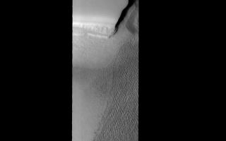 <h1>PIA01869:  Northern Dune Field</h1><div class="PIA01869" lang="en" style="width:800px;text-align:left;margin:auto;background-color:#000;padding:10px;max-height:150px;overflow:auto;"><p><a href="/figures/PIA01869_fig1.jpg"></a><br><b>Context image for PIA01869<br />Northern Dune Field</b></p><p>This image shows part of the large dune field (or erg) that exists surrounding the north polar ice cap.<p>Image information: VIS instrument. Latitude 83.8N, Longitude 227.8E. 40 meter/pixel resolution.</p><p>Please see the <a href="http://themis.asu.edu/terms" target="_blank">THEMIS Data Citation Note</a> for details on crediting THEMIS images.</p><p>Note: this THEMIS visual image has not been radiometrically nor geometrically calibrated for this preliminary release. An empirical correction has been performed to remove instrumental effects. A linear shift has been applied in the cross-track and down-track direction to approximate spacecraft and planetary motion. Fully calibrated and geometrically projected images will be released through the Planetary Data System in accordance with Project policies at a later time.</p><p>NASA's Jet Propulsion Laboratory manages the 2001 Mars Odyssey mission for NASA's Office of Space Science, Washington, D.C. The Thermal Emission Imaging System (THEMIS) was developed by Arizona State University, Tempe, in collaboration with Raytheon Santa Barbara Remote Sensing. The THEMIS investigation is led by Dr. Philip Christensen at Arizona State University. Lockheed Martin Astronautics, Denver, is the prime contractor for the Odyssey project, and developed and built the orbiter. Mission operations are conducted jointly from Lockheed Martin and from JPL, a division of the California Institute of Technology in Pasadena.</p><br /><br /><a href="http://photojournal.jpl.nasa.gov/catalog/PIA01869" onclick="window.open(this.href); return false;" title="Voir l'image 	 PIA01869:  Northern Dune Field	  sur le site de la NASA">Voir l'image 	 PIA01869:  Northern Dune Field	  sur le site de la NASA.</a></div>