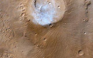 <h1>PIA02006:  Apollinaris Patera, Mars</h1><div class="PIA02006" lang="en" style="width:429px;text-align:left;margin:auto;background-color:#000;padding:10px;max-height:150px;overflow:auto;"><p>This month (April 1999), the Mars Global Surveyor Mars Orbiter Camera (MOC) passed over the Apollinaris Patera volcano and captured a patch of bright clouds hanging over its summit in the early martian afternoon. This ancient volcano is located near the equator and--based on observations from the 1970s Viking Orbiters--is thought to be as much as 5 kilometers (3 miles) high. The caldera--the semi-circular crater at the volcano summit--is about 80 kilometers (50 miles) across.</p><p>The color in this picture was derived from the MOC red and blue wide angle camera systems and does not represent true color as it would appear to the human eye (that is, if a human were in a position to be orbiting around the red planet). Illumination is from the upper left.</p><p>Malin Space Science Systems and the California Institute of Technology built the MOC using spare hardware from the Mars Observer mission. MSSS operates the camera from its facilities in San Diego, CA. The Jet Propulsion Laboratory's Mars Surveyor Operations Project operates the Mars Global Surveyor spacecraft with its industrial partner, Lockheed Martin Astronautics, from facilities in Pasadena, CA and Denver, CO.</p><br /><br /><a href="http://photojournal.jpl.nasa.gov/catalog/PIA02006" onclick="window.open(this.href); return false;" title="Voir l'image 	 PIA02006:  Apollinaris Patera, Mars	  sur le site de la NASA">Voir l'image 	 PIA02006:  Apollinaris Patera, Mars	  sur le site de la NASA.</a></div>