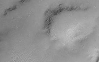 <h1>PIA02019:  MOC "Looking Into" Martian Craters</h1><div class="PIA02019" lang="en" style="width:290px;text-align:left;margin:auto;background-color:#000;padding:10px;max-height:150px;overflow:auto;"><p>During the first week of May 1999, the Mars Orbiter Camera (MOC) spent sometime peering into martian impact craters.</p><p>This crater is found on Hesperia Planum and is 7.3 kilometers (4.5 miles) across. Illumination is from the upper left.</p><p>If you have ever visited the famous Meteor Crater in northern Arizona, U.S.A., then you are aware of its immense size on a human scale. The Arizona crater, however, is only 1 kilometer across (0.62 miles), this crater is seven times wider.</p><p>This crater was formed by the impact and explosion of a meteorite at some time in the martian past. After the crater formed, it was modified by wind and erosion. The crater shows deposits of sand and dust on the floor and in low areas around their rim, also boulders and other debris that has slid down the inside walls of the crater; and some crater walls show exposures of bedrock.</p><p>Malin Space Science Systems and the California Institute of Technology built the MOC using spare hardware from the Mars Observer mission. MSSS operates the camera from its facilities in San Diego, CA. The Jet Propulsion Laboratory's Mars Surveyor Operations Project operates the Mars Global Surveyor spacecraft with its industrial partner, Lockheed Martin Astronautics, from facilities in Pasadena, CA and Denver, CO.</p><br /><br /><a href="http://photojournal.jpl.nasa.gov/catalog/PIA02019" onclick="window.open(this.href); return false;" title="Voir l'image 	 PIA02019:  MOC "Looking Into" Martian Craters	  sur le site de la NASA">Voir l'image 	 PIA02019:  MOC "Looking Into" Martian Craters	  sur le site de la NASA.</a></div>