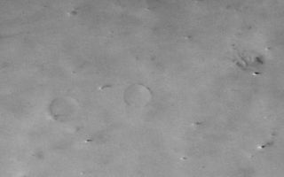 <h1>PIA02087:  Large Martian Dust Devils Caught in the Act</h1><div class="PIA02087" lang="en" style="width:550px;text-align:left;margin:auto;background-color:#000;padding:10px;max-height:150px;overflow:auto;"><p><br><br><p><b>141 c</b></p></p><p>What is 8 kilometers (5 miles) high, forms in the mid-afternoon, and cannot be found the next day?</p><p>A Martian dust devil! The arrow in the left image (MOC2-141a, above) points to the tallest (8 km, 5 mi) of several dust devils spied by the Mars Global Surveyor MOC Wide Angle camera during its global <a href="http://www.msss.com/mars/global_surveyor/camera/images/5_17_99_geodesy/index.html">geodesy campaign</a> in May.</p><p>The above two pictures (MOC2-141a and MOC2-141b, top row) are centered near 36°N, 159°W in northern Amazonis Planitia. Each image covers an area 88 kilometers(55 miles) across, and each shows similar features on the ground, such as the two partially-buried craters at the center left.</p><p>Each image also shows features that are not found in the other image. These are dust devils. Each scene is illuminated by sunlight from the lower left-- thus each towering dust devil casts a long, dark shadow that points toward the right/upper right. The "movie" (lower row, MOC2-141c) shows a comparison of the two images. When viewing the "movie," note that permanent features such as the two partly buried craters do not move, but the dust devils in one image do not appear in the other. Different dust devils are seen in each of the two images. Other variations in apparent surface brightness are also seen when the two images are compared--these are thought to be places where smaller, ground-hugging dust plumes are also being "kicked-up" by the wind.</p><p>The pictures were taken 2 days apart--the first on May 13, 1999, the second on May 15, 1999. Large dust devils were known to occur in this region because they were seen in Viking images 20 years ago, but the new and repeated coverage by MOC gives more information about the dust devil's shape and occurrence. Dust devils are columnar vortices of wind that move across the landscape, pick up dust, and look somewhat like miniature tornadoes. For more information on dust devils, see MOC image release MOC2-60 from July 1998, <a href="http://www.msss.com/mars/global_surveyor/camera/images/7_30_98_devil_rel/index.html">"SUV Tracks on Mars? The Devil is in the Details."</a></p><p>Malin Space Science Systems and the California Institute of Technology built the MOC using spare hardware from the Mars Observer mission. MSSS operates the camera from its facilities in San Diego, CA. The Jet Propulsion Laboratory's Mars Surveyor Operations Project operates the Mars Global Surveyor spacecraft with its industrial partner, Lockheed Martin Astronautics, from facilities in Pasadena, CA and Denver, CO.</p><br /><br /><a href="http://photojournal.jpl.nasa.gov/catalog/PIA02087" onclick="window.open(this.href); return false;" title="Voir l'image 	 PIA02087:  Large Martian Dust Devils Caught in the Act	  sur le site de la NASA">Voir l'image 	 PIA02087:  Large Martian Dust Devils Caught in the Act	  sur le site de la NASA.</a></div>