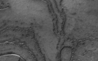 <h1>PIA02168:  South Polar Terraces</h1><div class="PIA02168" lang="en" style="width:466px;text-align:left;margin:auto;background-color:#000;padding:10px;max-height:150px;overflow:auto;"><p>9 February 2006<br />This Mars Global Surveyor (MGS) Mars Orbiter Camera (MOC) image shows layering in terrain at the high southern latitudes of Mars. South polar layers are commonly assumed to consist of varying amounts of dust and ice. An alternative explanation -- they may be exposures of ancient sedimentary rock.</p><p>Location near: 78.9°S, 10.1°W <br />Image width: ~3 km (~1.9 mi) <br />Illumination from: upper left <br />Season: Southern Summer </p><br /><br /><a href="http://photojournal.jpl.nasa.gov/catalog/PIA02168" onclick="window.open(this.href); return false;" title="Voir l'image 	 PIA02168:  South Polar Terraces	  sur le site de la NASA">Voir l'image 	 PIA02168:  South Polar Terraces	  sur le site de la NASA.</a></div>