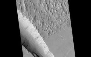 <h1>PIA02326:  Diverse Geologic Features of Western Tharsis, Mars</h1><div class="PIA02326" lang="en" style="width:365px;text-align:left;margin:auto;background-color:#000;padding:10px;max-height:150px;overflow:auto;"><p>This pair of Mars Global Surveyor (MGS) Mars Orbiter Camera (MOC) images shows a variety of geologic features along the eastern edge of the Gigas Sulci (the rough, ridged surface at upper left in each picture) in western Tharsis. This is a volcanic region located approximately 750 km (470 mi) northwest of the Pavonis Mons volcano and 350 km (220 mi) southeast of the Olympus Mons volcano.</p><p>The regional view (above, left) is a MOC wide angle context image showing the location of the higher resolution, narrow angle camera view (above, right) as a small, white box. The upper left portion of the context image shows a rough, hilly terrain--Gigas Sulci--that is cut along its margins by several troughs that look something like gashes made by a giant knife. Also in this scene are several impact craters, including one (upper right) with a bright, teardrop-shaped "tail" formed by wind. The context frame covers an area approximately 115 kilometers (71 miles) across and is illuminated from the left. North is up.</p><p>The high resolution picture (above, right) is a MOC narrow angle camera view of a 3 km-(1.9 mi)-wide area along the edge of the hilly, Gigas Sulci terrain. This image shows a range of interesting geologic features. The Gigas Sulci consist of steep, somewhat mountainous terrain, but the valleys and some of the slopes between these hills appear smooth and mantled (perhaps by dust). Small, parallel ridges on some of the valley floors are probably windblown dunes. The edge of the hilly terrain is cut by a deep trough caused by faulting and down-dropping of the terrain in the center of the valley. The slopes of this valley exhibit dark streaks caused by small landslides. Boulders the size of small buildings can also be seen on some of these slopes. This deep trough and another, shallower one to the south (lower left) cut across lava flows, indicating that the troughs formed after the lava flows were emplaced, cooled, and hardened. The trough at the lower left has slumped and terraced walls. As in the context frame, nor this up and the sun illuminates the scene from the left.</p><p>For a full-resolution (3.7 meters--12 feet--per pixel) view of the narrow angle camera image (2.9 Mbytes), Click <a href="http://www.msss.com/mars_images/9_7_99_tharsisdet/moc2_msss_tharsisdet_100.gif">HERE</a>.</p><p>Malin Space Science Systems and the California Institute of Technology built the MOC using spare hardware from the Mars Observer mission. MSSS operates the camera from its facilities in San Diego, CA. The Jet Propulsion Laboratory's Mars Surveyor Operations Project operates the Mars Global Surveyor spacecraft with its industrial partner, Lockheed Martin Astronautics, from facilities in Pasadena, CA and Denver, CO.</p><br /><br /><a href="http://photojournal.jpl.nasa.gov/catalog/PIA02326" onclick="window.open(this.href); return false;" title="Voir l'image 	 PIA02326:  Diverse Geologic Features of Western Tharsis, Mars	  sur le site de la NASA">Voir l'image 	 PIA02326:  Diverse Geologic Features of Western Tharsis, Mars	  sur le site de la NASA.</a></div>