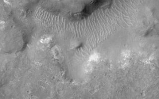 <h1>PIA02340:  The Terrain of Margaritifer Chaos</h1><div class="PIA02340" lang="en" style="width:800px;text-align:left;margin:auto;background-color:#000;padding:10px;max-height:150px;overflow:auto;"><p></p><p>The jumbled and broken terrain in the picture on the left is known as chaotic terrain. Chaotic terrain was first observed in Mariner 6 and 7 images of Mars more than 30 years ago, and is thought to result from collapse after material--perhaps water or ice--was removed from the subsurface by events such as the formation of giant flood channels. The region shown here is named "Margaritifer Chaos." The left picture is a Mars Global Surveyor (MGS) Mars Orbiter Camera (MOC) red wide angle camera context frame that covers an area 115 km (71 miles) across. The small white box is centered at 10.3°S, 21.4°W and indicates the location of the high-resolution view on the right. The high resolution view (right) covers a small portion of the Margaritifer Chaos at 1.8 meters (6 feet) per pixel. The area shown is 3 km (1.9 miles) across. Uplands are lumpy with small bright outcrops of bedrock. Lowlands or valleys in the chaotic terrain have floors covered by light-toned windblown d rifts. This image is typical of the very highest-resolution views of the equatorial latitudes of Mars. Both pictures are illuminated from the left/upper left, north is toward the top.<br /><br /><a href="http://photojournal.jpl.nasa.gov/catalog/PIA02340" onclick="window.open(this.href); return false;" title="Voir l'image 	 PIA02340:  The Terrain of Margaritifer Chaos	  sur le site de la NASA">Voir l'image 	 PIA02340:  The Terrain of Margaritifer Chaos	  sur le site de la NASA.</a></div>