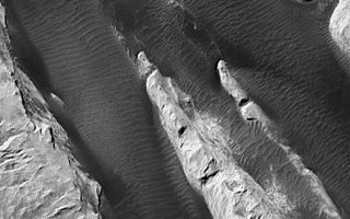 <h1>PIA02849:  White Rock' of Pollack Crater</h1><div class="PIA02849" lang="en" style="width:518px;text-align:left;margin:auto;background-color:#000;padding:10px;max-height:150px;overflow:auto;"><a href="/figures/moc2-264bigfig.jpg"></a><p>"White Rock" is a ridged mound that was first seen and informally named "White Rock" in pictures from the Mariner 9 orbiter in 1972. In black-and-white photos, the feature appears much brighter than its surrounding terrain, giving the impression that the material is white. Later analyses of Mariner 9, Viking, and Mars Global Surveyor (MGS) data showed that the feature isn't actually white, it is somewhat red and reflects only about 20-25% of the sunlight that falls upon it (a white surface would reflect 100%).<p>Located in Pollack Crater, a 95 km (59 mile) wide impact basin at 7.9°S, 334.7°W, White Rock is the light-red/orange feature with the rectangular white box drawn on it in the context view above. The white box indicates the location of a sub-frame of a MGS Mars Orbiter Camera (MOC) image acquired in September 2000, shown in <a href="/catalog/PIA02848">PIA02848</a>. The light-toned material that gives White Rock its name forms steep cliffs with valleys between them covered by dark, windblown, rippled sand. This release image shows a close-up of a portion of <a href="/catalog/PIA02848">PIA02848</a>, illustrating that the bright material is layered (arrow, "layers") and that there is an old impact crater (arrow, "crater") that has been partly uncovered from beneath the White Rock material.<p>The layering in White Rock suggests that the material is sediment deposited at some time in the distant past within Pollack Crater. The fact that the material erodes to form steep cliffs suggests that it is hard like rock. Thus, White Rock is interpreted to be an outcrop of sedimentary rock. It is probably a small remnant of a larger body of rock that may have once covered the entire floor of Pollack Crater; this view is supported by the observation that more extensive layered rocks are seen in other craters across the surface of the red planet (e.g., the crater at 8°N, 7°W).<p>Both pictures shown here are illuminated by sunlight from the upper left, north is up. Pollack Crater was named in 1997 for James B. Pollack (1938-1994), a NASA Ames Research Center scientist known in the Mars research community for his atmospheric research with Mariner 9 and Viking data and the development of key computer models used to investigate the red planet's winds, storms, and climate.<br /><br /><a href="http://photojournal.jpl.nasa.gov/catalog/PIA02849" onclick="window.open(this.href); return false;" title="Voir l'image 	 PIA02849:  White Rock' of Pollack Crater	  sur le site de la NASA">Voir l'image 	 PIA02849:  White Rock' of Pollack Crater	  sur le site de la NASA.</a></div>