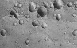 <h1>PIA03019:  Secondary Craters</h1><div class="PIA03019" lang="en" style="width:672px;text-align:left;margin:auto;background-color:#000;padding:10px;max-height:150px;overflow:auto;"><p>7 October 2005<br />This Mars Global Surveyor (MGS) Mars Orbiter Camera (MOC) image shows a cluster of craters in far western Arabia Terra. The crater cluster is oriented along a line that runs nearly east-west (left-right) across the scene. Clusters of craters positioned along a line like this are secondary craters -- that is, they formed as the result of a much larger meteor, asteroid, or cometary impact somewhere else in the region. These craters do not form from the object that impacted Mars to form the larger, primary crater; these are the product of the impact of the rocks and debris thrown out by the larger impact.<p>Location near: 14.9°N, 19.3°W <br />Image width: width: ~3 km (~1.9 mi) <br />Illumination from: lower left <br />Season: Northern Autumn</p><br /><br /><a href="http://photojournal.jpl.nasa.gov/catalog/PIA03019" onclick="window.open(this.href); return false;" title="Voir l'image 	 PIA03019:  Secondary Craters	  sur le site de la NASA">Voir l'image 	 PIA03019:  Secondary Craters	  sur le site de la NASA.</a></div>
