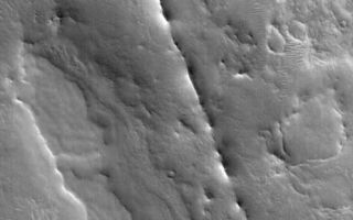 <h1>PIA03037:  Dike near Auqakuh</h1><div class="PIA03037" lang="en" style="width:462px;text-align:left;margin:auto;background-color:#000;padding:10px;max-height:150px;overflow:auto;"><p>13 October 2005<br />This Mars Global Surveyor (MGS) Mars Orbiter Camera (MOC) image shows a dike exhumed by erosion from beneath the cratered terrain near Auqakuh Vallis in northeastern Arabia Terra. The dike is the narrow, discontinuous ridge that cuts diagonally from the northwest (upper left) toward the southeast (lower right) across the scene. Typically, a dike is formed underground when molten rock -- magma -- is injected through a crack or fault. The magma eventually cools and hardens. A dike can also sometimes form in a non-volcanic setting by injection of wet sediment (which later hardens to rock) into an overlying sedimentary layer. The ridge is formed later, when surrounding rocks are eroded away, leaving the more erosion-resistant rock behind as a ridge. For an example on Earth, the famous Shiprock in northwestern New Mexico, U.S.A., has several dikes associated with it.<p>Location near: 31.4°N, 299.0°W <br />Image width: width: ~3 km (~1.9 mi) <br />Illumination from: lower left <br />Season: Northern Winter </p><br /><br /><a href="http://photojournal.jpl.nasa.gov/catalog/PIA03037" onclick="window.open(this.href); return false;" title="Voir l'image 	 PIA03037:  Dike near Auqakuh	  sur le site de la NASA">Voir l'image 	 PIA03037:  Dike near Auqakuh	  sur le site de la NASA.</a></div>