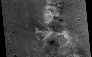 <h1>PIA03253:  Spirit Rover on 'Husband Hill'</h1><div class="PIA03253" lang="en" style="width:800px;text-align:left;margin:auto;background-color:#000;padding:10px;max-height:150px;overflow:auto;"><p><a href="/figures/PIA03253_fig1.jpg"></a><b><br />Figure 1: Location of Spirit</b></p><p>Two Earth years ago, NASA's Mars Exploration Rover Spirit touched down in Gusev Crater. The rover marked its first Mars-year (687 Earth days) anniversary in November 2005. Shortly before Spirit's Martian anniversary, the Mars Orbiter Camera on NASA's Mars Global Surveyor acquired an image covering approximately 3 kilometers by 3 kilometers (1.9 miles by 1.9 miles) centered on the rover's location at that time in the "Columbia Hills." </p><p>"Husband Hill," the tallest in the range, is just below the center of the image. The image has a resolution of about 50 centimeters (1.6 feet) per pixel. North is up; illumination is from the left. The location is near 14.8 degrees south latitude, 184.6 degrees west longitude. </p><p>The image was acquired on Nov. 2, 2005. A white box (see Figure 1) indicates the location of an excerpted portion on which the location of Spirit on that date is marked. Dr. Timothy J. Parker of the Mars Exploration Rover team at the NASA's Jet Propulsion Laboratory, Pasadena, Calif., confirmed the location of the rover in the image. The region toward the bottom of the image shows the area where the rover is currently headed. The large dark patch and other similar dark patches are accumulations of windblown sand and granules. </p><br /><br /><a href="http://photojournal.jpl.nasa.gov/catalog/PIA03253" onclick="window.open(this.href); return false;" title="Voir l'image 	 PIA03253:  Spirit Rover on 'Husband Hill'	  sur le site de la NASA">Voir l'image 	 PIA03253:  Spirit Rover on 'Husband Hill'	  sur le site de la NASA.</a></div>