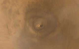 <h1>PIA03470:  Arsia Mons Spiral Cloud</h1><div class="PIA03470" lang="en" style="width:800px;text-align:left;margin:auto;background-color:#000;padding:10px;max-height:150px;overflow:auto;"><p>One of the benefits of the Mars Global Surveyor (MGS) Mars Orbiter Camera (MOC) Extended Mission is the opportunity to observe how the planet's weather changes during a second full martian year. This picture of Arsia Mons was taken June 19, 2001; southern spring equinox occurred the same day. Arsia Mons is a volcano nearly large enough to cover the state of New Mexico. On this particular day (the first day of Spring), the MOC wide angle cameras documented an unusual spiral-shaped cloud within the 110 km (68 mi) diameter caldera--the summit crater--of the giant volcano. Because the cloud is bright both in the red and blue images acquired by the wide angle cameras, it probably consisted mostly of fine dust grains. The cloud's spin may have been induced by winds off the inner slopes of the volcano's caldera walls resulting from the temperature differences between the walls and the caldera floor, or by a vortex as winds blew up and over the caldera. Similar spiral clouds were seen inside the caldera for several days; we don't know if this was a single cloud that persisted throughout that time or one that regenerated each afternoon. Sunlight illuminates this scene from the left/upper left.<p>Malin Space Science Systems and the California Institute of Technology built the MOC using spare hardware from the Mars Observer mission. MSSS operates the camera from its facilities in San Diego, CA. The Jet Propulsion Laboratory's Mars Surveyor Operations Project operates the Mars Global Surveyor spacecraft with its industrial partner, Lockheed Martin Astronautics, from facilities in Pasadena, CA and Denver, CO.<br /><br /><a href="http://photojournal.jpl.nasa.gov/catalog/PIA03470" onclick="window.open(this.href); return false;" title="Voir l'image 	 PIA03470:  Arsia Mons Spiral Cloud	  sur le site de la NASA">Voir l'image 	 PIA03470:  Arsia Mons Spiral Cloud	  sur le site de la NASA.</a></div>
