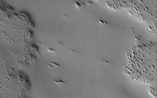 <h1>PIA03547:  Dust-covered Flow</h1><div class="PIA03547" lang="en" style="width:507px;text-align:left;margin:auto;background-color:#000;padding:10px;max-height:150px;overflow:auto;"><p>17 November 2005<br />This Mars Global Surveyor (MGS) Mars Orbiter Camera (MOC) image shows an ancient lava flow surface near the volcano, Ascraeus Mons. The volcanic material has been completely covered by thick accumulations of dust. An earlier accumulation of dust or ash was eroded by wind to form the sharp, nearly triangular hills and ridges seen on top of the flow surfaces. A small impact crater with bouldery ejecta has formed on top of the old flow material in the southern (lower) quarter of the image.<p>Location near: 8.5°N, 110.5°W <br />Image width: width: ~3 km (~1.9 mi) <br />Illumination from: lower left <br />Season: Northern Autumn </p><br /><br /><a href="http://photojournal.jpl.nasa.gov/catalog/PIA03547" onclick="window.open(this.href); return false;" title="Voir l'image 	 PIA03547:  Dust-covered Flow	  sur le site de la NASA">Voir l'image 	 PIA03547:  Dust-covered Flow	  sur le site de la NASA.</a></div>