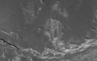 <h1>PIA03660:  Eos Chaos Rocks</h1><div class="PIA03660" lang="en" style="width:669px;text-align:left;margin:auto;background-color:#000;padding:10px;max-height:150px;overflow:auto;"><p>11 January 2006<br />This Mars Global Surveyor (MGS) Mars Orbiter Camera (MOC) image shows light-toned, layered rock outcrops in Eos Chaos, located near the east end of the Valles Marineris trough system. The outcrops occur in the form of a distinct, circular butte (upper half of image) and a high slope (lower half of image). The rocks might be sedimentary rocks, similar to those found elsewhere exposed in the Valles Marineris system and the chaotic terrain to the east of the region.</p><p>Location near: 12.9°S, 49.5°W <br />Image width: ~3 km (~1.9 mi) <br />Illumination from: lower left <br />Season: Southern Summer </p><br /><br /><a href="http://photojournal.jpl.nasa.gov/catalog/PIA03660" onclick="window.open(this.href); return false;" title="Voir l'image 	 PIA03660:  Eos Chaos Rocks	  sur le site de la NASA">Voir l'image 	 PIA03660:  Eos Chaos Rocks	  sur le site de la NASA.</a></div>