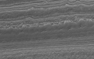 <h1>PIA03689:  Southern Terrain</h1><div class="PIA03689" lang="en" style="width:673px;text-align:left;margin:auto;background-color:#000;padding:10px;max-height:150px;overflow:auto;"><p>22 January 2006<br />This Mars Global Surveyor (MGS) Mars Orbiter Camera (MOC) image shows an eroded landscape in the south polar region of Mars. Layered material has been exposed to create a complex pattern of steps and low, isolated mesas. The material has also been cracked, and semi-parallel ridges on some of the 'stairsteps' may be old, windblown ripples.</p><p>Location near: 86.0°S, 182.1°W <br />Image width: ~3 km (~1.9 mi) <br />Illumination from: upper left <br />Season: Southern Summer </p><br /><br /><a href="http://photojournal.jpl.nasa.gov/catalog/PIA03689" onclick="window.open(this.href); return false;" title="Voir l'image 	 PIA03689:  Southern Terrain	  sur le site de la NASA">Voir l'image 	 PIA03689:  Southern Terrain	  sur le site de la NASA.</a></div>