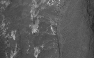 <h1>PIA03698:  Terby's Rocks</h1><div class="PIA03698" lang="en" style="width:597px;text-align:left;margin:auto;background-color:#000;padding:10px;max-height:150px;overflow:auto;"><p>27 January 2006<br />This Mars Global Surveyor (MGS) Mars Orbiter Camera (MOC) image shows some of the light-toned, layered, sedimentary rock outcrops in northern Terby Crater. Terby is located along the north edge of Hellas Planitia. The sedimentary rocks might have been deposited in a greater, Hellas-filling sea -- or not. Today, the rocks are partly covered by dark-toned sediment and debris.</p><p>Location near: 27.2°S, 285.3°W <br />Image width: ~3 km (~1.9 mi) <br />Illumination from: upper left <br />Season: Southern Summer </p><br /><br /><a href="http://photojournal.jpl.nasa.gov/catalog/PIA03698" onclick="window.open(this.href); return false;" title="Voir l'image 	 PIA03698:  Terby's Rocks	  sur le site de la NASA">Voir l'image 	 PIA03698:  Terby's Rocks	  sur le site de la NASA.</a></div>