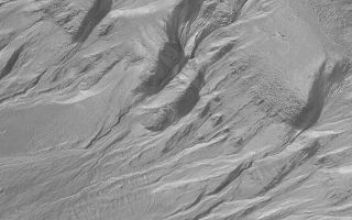 <h1>PIA03754:  Gullies and Layers in Crater Wall in Newton</h1><div class="PIA03754" lang="en" style="width:800px;text-align:left;margin:auto;background-color:#000;padding:10px;max-height:150px;overflow:auto;">This dramatic view of gullies emergent from layered outcrops occurs on the wall of a crater within the much larger impact basin, Newton. Newton Crater and its surrounding terrain exhibit many examples of gullies on the walls of craters and troughs. The gullies exhibit meandering channels with fan-shaped aprons of debris located downslope. The gullies are considered to have been formed by erosion--both from a fluid (such as water) running downslope, and by slumping and landsliding processes driven by the force of gravity. This picture was obtained by the Mars Global Surveyor (MGS) Mars Orbiter Camera (MOC) in March 2001; it is illuminated from the upper left and covers an area 3 km (1.9 mi) across.<br /><br /><a href="http://photojournal.jpl.nasa.gov/catalog/PIA03754" onclick="window.open(this.href); return false;" title="Voir l'image 	 PIA03754:  Gullies and Layers in Crater Wall in Newton	  sur le site de la NASA">Voir l'image 	 PIA03754:  Gullies and Layers in Crater Wall in Newton	  sur le site de la NASA.</a></div>