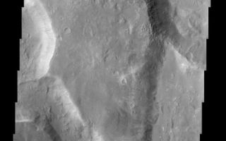 <h1>PIA03765:  Uzboi Vallis, Nirgal Vallis, and Luki Crater</h1><div class="PIA03765" lang="en" style="width:474px;text-align:left;margin:auto;background-color:#000;padding:10px;max-height:150px;overflow:auto;"><br>(Released 9 April 2002)<br>This THEMIS image captures two channels (Nirgal Vallis is the smaller sinuous channel on the left and Uzboi Vallis is the larger channel located in the lower right) and Luki Crater located in the upper right. The mouth of Nirgal Vallis appears to be truncated by Uzboi Vallis. This indicates that Nirgal Vallis is an older channel than Uzboi Vallis. The floor of Uzboi Vallis was subsequently bombarded by an asteroid or comet which gouged out the 21 km diameter crater named Luki. Luki is named after a town in the Ukraine. Uzboi is the name of a dry river in Russia. Nirgal is the Babylonian name for Mars. Gullies and alluvial deposits discovered by Mars Global Surveyor are clearly visible on the polar-facing (south) wall and floor of Nirgal Vallis and also in the inner rim of Luki crater. These gullies appear to emanate from a specific layer in the walls. There is a pronounced sparsity of gullies on the equator-ward facing slopes but some are present in this image. The gullies have been proposed to have formed by the subsurface release of water. The western channel wall of Uzboi Vallis does not appear to have the fine-scale gullying as does Nirgal Vallis. However, the western channel wall of Uzboi Vallis does show some evidence of downslope movement (mass wasting). Some patches of dunes are also seen on the channel floor, notably along the edges of the channel floor near the canyon walls. There is also a landslide located along the southern wall of Luki Crater.<br /><br /><a href="http://photojournal.jpl.nasa.gov/catalog/PIA03765" onclick="window.open(this.href); return false;" title="Voir l'image 	 PIA03765:  Uzboi Vallis, Nirgal Vallis, and Luki Crater	  sur le site de la NASA">Voir l'image 	 PIA03765:  Uzboi Vallis, Nirgal Vallis, and Luki Crater	  sur le site de la NASA.</a></div>