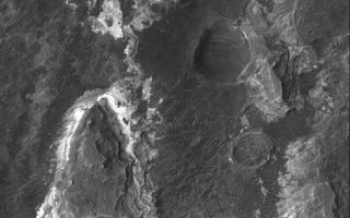 <h1>PIA03928:  Ladon Sedimentary Rocks</h1><div class="PIA03928" lang="en" style="width:800px;text-align:left;margin:auto;background-color:#000;padding:10px;max-height:150px;overflow:auto;"><p>6 June 2005<br />This Mars Global Surveyor (MGS) Mars Orbiter Camera (MOC) image shows light-toned, layered, sedimentary rocks exposed by the fluids that carved the Ladon Valles system in the Erythraeum region of Mars. These rocks are so ancient that their sediments were deposited, cemented to form rock, and then eroded by the water (or other liquid) that carved Ladon Valles, so far back in Martian history that such liquids could still flow on the planet's surface.</p><p>Location near: 20.8°S, 30.0°W <br />Image width: ~3 km (~1.9 mi <br />Illumination from: upper left <br />Season: Southern Spring <br /></p><br /><br /><a href="http://photojournal.jpl.nasa.gov/catalog/PIA03928" onclick="window.open(this.href); return false;" title="Voir l'image 	 PIA03928:  Ladon Sedimentary Rocks	  sur le site de la NASA">Voir l'image 	 PIA03928:  Ladon Sedimentary Rocks	  sur le site de la NASA.</a></div>