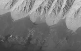 <h1>PIA03954:  Candor Chasma Features</h1><div class="PIA03954" lang="en" style="width:800px;text-align:left;margin:auto;background-color:#000;padding:10px;max-height:150px;overflow:auto;"><p>17 June 2005<br />This Mars Global Surveyor (MGS) Mars Orbiter Camera (MOC) image shows dark, windblown sand and an eroded slope of massively-bedded, light-toned, sedimentary rock. These landforms are located in east/central Candor Chasma.</p><p>Location near: 6.8°S, 71.7°W <br />Image width: ~3 km (~1.9 mi) <br />Illumination from: upper left <br />Season: Southern Spring <br /></p><br /><br /><a href="http://photojournal.jpl.nasa.gov/catalog/PIA03954" onclick="window.open(this.href); return false;" title="Voir l'image 	 PIA03954:  Candor Chasma Features	  sur le site de la NASA">Voir l'image 	 PIA03954:  Candor Chasma Features	  sur le site de la NASA.</a></div>