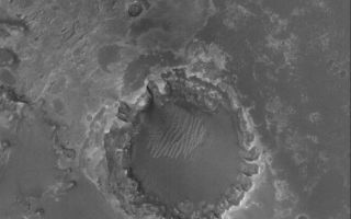 <h1>PIA04197:  Meridiani Crater</h1><div class="PIA04197" lang="en" style="width:648px;text-align:left;margin:auto;background-color:#000;padding:10px;max-height:150px;overflow:auto;"><p>31 August 2005<br />This Mars Global Surveyor (MGS) Mars Orbiter Camera (MOC) image shows a crater formed in light-toned, layered, sedimentary rocks in Meridiani Planum. This crater is located approximately 55 kilometers (~34 miles) southwest of the Mars Exploration Rover, Opportunity, site. Erosion of sedimentary rock layers around the crater rim has caused an uneven retreat, resulting in the formation of U-shaped alcoves where undermining and collapse have occurred. Dark material in this scene is probably sand and granules, similar to the dark surfaces explored by the Opportunity rover.</p><p>Location near: 3.1°S, 5.8°W <br />Image width: width: ~3 km (~1.9 mi) <br />Illumination from: lower left <br />Season: Southern Spring </p><br /><br /><a href="http://photojournal.jpl.nasa.gov/catalog/PIA04197" onclick="window.open(this.href); return false;" title="Voir l'image 	 PIA04197:  Meridiani Crater	  sur le site de la NASA">Voir l'image 	 PIA04197:  Meridiani Crater	  sur le site de la NASA.</a></div>