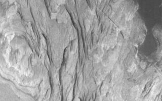 <h1>PIA04259:  Sediments of Terby</h1><div class="PIA04259" lang="en" style="width:495px;text-align:left;margin:auto;background-color:#000;padding:10px;max-height:150px;overflow:auto;"><p>4 September 2005<br />This Mars Global Surveyor (MGS) Mars Orbiter Camera (MOC) image shows light-toned, layered, sedimentary rocks exposed by erosion in Terby Crater, located on the north rim of the Hellas Basin. Sedimentary rocks are common on Mars; the light tone of the rocks here suggests that they might bear some similarity to the sedimentary rocks of Meridiani Planum, explored by the Mars Exploration Rover, Opportunity. Water was likely involved in the alteration of the rocks, and perhaps in their deposition as sediments, long ago.</p><p>Location near: 27.9°S, 285.6°W <br />Image width: width: ~3 km (~1.9 mi) <br />Illumination from: upper left <br />Season: Southern Spring </p><br /><br /><a href="http://photojournal.jpl.nasa.gov/catalog/PIA04259" onclick="window.open(this.href); return false;" title="Voir l'image 	 PIA04259:  Sediments of Terby	  sur le site de la NASA">Voir l'image 	 PIA04259:  Sediments of Terby	  sur le site de la NASA.</a></div>