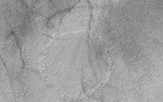 <h1>PIA04486:  Boulder Ring</h1><div class="PIA04486" lang="en" style="width:540px;text-align:left;margin:auto;background-color:#000;padding:10px;max-height:150px;overflow:auto;">MGS MOC Release No. MOC2-345, 29 April 2003<p>This Mars Global Surveyor (MGS) Mars Orbiter Camera (MOC) image shows a ring of boulders on the floor of a southern mid-latitude basin. The sharp, inner ring of boulders and knobs is the location of the rim of a filled and buried impact crater. The outer, diffuse ring of boulders is the material ejected from the impact crater when it formed. The crater and its ejecta are only thinly buried beneath the surface. This feature is located near 55.5°S, 333.3°W. Sunlight illuminates the scene from the upper left.<p><br /><br /><a href="http://photojournal.jpl.nasa.gov/catalog/PIA04486" onclick="window.open(this.href); return false;" title="Voir l'image 	 PIA04486:  Boulder Ring	  sur le site de la NASA">Voir l'image 	 PIA04486:  Boulder Ring	  sur le site de la NASA.</a></div>