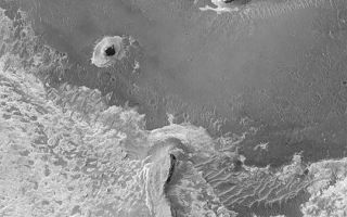 <h1>PIA04492:  Meridiani Cliffs and Buttes</h1><div class="PIA04492" lang="en" style="width:540px;text-align:left;margin:auto;background-color:#000;padding:10px;max-height:150px;overflow:auto;">MGS MOC Release No. MOC2-347, 1 May 2003<p>This Mars Global Surveyor (MGS) Mars Orbiter Camera (MOC) image of layered sedimentary rock outcrops in northern Sinus Meridiani shows several buttes and ridges formed in rock that is somewhat resistant to erosion. The circular feature near the bottom of the picture is an old impact crater that was filled, then buried within the layered material, then later partially exhumed. The sinuous ridge and small buttes to the right of the exhumed crater are composed of the same rock materials that once buried the crater. The picture covers an area about 3 km (1.9 mi) wide near 2.3°N, 353.6°W. Sunlight illuminates the scene from the left.<p><br /><br /><a href="http://photojournal.jpl.nasa.gov/catalog/PIA04492" onclick="window.open(this.href); return false;" title="Voir l'image 	 PIA04492:  Meridiani Cliffs and Buttes	  sur le site de la NASA">Voir l'image 	 PIA04492:  Meridiani Cliffs and Buttes	  sur le site de la NASA.</a></div>
