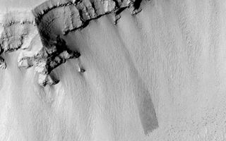 <h1>PIA04525:  Layers, Boulders, and Dust</h1><div class="PIA04525" lang="en" style="width:799px;text-align:left;margin:auto;background-color:#000;padding:10px;max-height:150px;overflow:auto;">MGS MOC Release No. MOC2-364, 18 May 2003<p>This Mars Global Surveyor (MGS) Mars Orbiter Camera (MOC) picture shows the wall of a trough in the Zephyrus Fossae region, west of the Elysium Rise near 27.9°N, 217.5°W. The trough wall has cut through and exposed layered bedrock, visible near the top of the wall. Talus covers the lower portions of the wall; this debris includes many automobile- and house-sized boulder--most of which are seen as dark dots at the base of the slope. Dust has coated and mantled much of this terrain, including some of the boulders. The dark streak near the center of the picture was formed by landsliding (or avalanching) of some of the dust. Sunlight illuminates the scene from the lower left.<p><br /><br /><a href="http://photojournal.jpl.nasa.gov/catalog/PIA04525" onclick="window.open(this.href); return false;" title="Voir l'image 	 PIA04525:  Layers, Boulders, and Dust	  sur le site de la NASA">Voir l'image 	 PIA04525:  Layers, Boulders, and Dust	  sur le site de la NASA.</a></div>