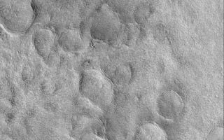 <h1>PIA04526:  Buried Craters of Utopia</h1><div class="PIA04526" lang="en" style="width:799px;text-align:left;margin:auto;background-color:#000;padding:10px;max-height:150px;overflow:auto;">MGS MOC Release No. MOC2-365, 19 May 2003<p>Beneath the northern plains of Mars are numerous buried meteor impact craters. One of the most heavily-cratered areas, although buried, occurs in Utopia Planitia, as shown in this Mars Global Surveyor (MGS) Mars Orbiter Camera (MOC) image. The history of Mars is complex; impact craters provide a tool by which to understand some of that history. In this case, a very ancient, cratered surface was thinly-buried by younger material that is not cratered at all. This area is near 48.1°N, 228.2°W; less than 180 km (112 mi) west of the Viking 2 lander site. Sunlight illuminates the scene from the lower left.<p><br /><br /><a href="http://photojournal.jpl.nasa.gov/catalog/PIA04526" onclick="window.open(this.href); return false;" title="Voir l'image 	 PIA04526:  Buried Craters of Utopia	  sur le site de la NASA">Voir l'image 	 PIA04526:  Buried Craters of Utopia	  sur le site de la NASA.</a></div>