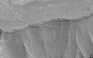 <h1>PIA04540:  Layered Walls of West Candor</h1><div class="PIA04540" lang="en" style="width:540px;text-align:left;margin:auto;background-color:#000;padding:10px;max-height:150px;overflow:auto;">MGS MOC Release No. MOC2-370, 24 May 2003<p>West Candor is part of the vast Valles Marineris trough system. These chasms and canyons cut through ancient, layered bedrock. This Mars Global Surveyor (MGS) Mars Orbiter Camera (MOC) picture shows some of the layering revealed in the wall and on the upland surface outside of southwest Candor Chasma. This image is located near 6.7°S, 76.8°W. Sunlight illuminates the scene from the right/lower right.<p><br /><br /><a href="http://photojournal.jpl.nasa.gov/catalog/PIA04540" onclick="window.open(this.href); return false;" title="Voir l'image 	 PIA04540:  Layered Walls of West Candor	  sur le site de la NASA">Voir l'image 	 PIA04540:  Layered Walls of West Candor	  sur le site de la NASA.</a></div>