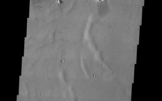 <h1>PIA04544:  Crater in the Mangala Valles Region</h1><div class="PIA04544" lang="en" style="width:518px;text-align:left;margin:auto;background-color:#000;padding:10px;max-height:150px;overflow:auto;"><p><a href="/figures/PIA04544_context.jpg"></a><br><p>Released 26 May 2003<p>Just south of the 2 km high main mass of the Medusae Fossae Formation, in a region dissected by channels, lies an unnamed crater that may have been filled by mud. A channel spills into this crater on its eastern side and may have delivered the material that now covers the floor of the crater. The subdued ridges may be wrinkle ridges in a preexisting lava flow that are now covered by a layer of sediment. The cracked surface is evidence for the subsequent deposition of mud.<p>Image information: VIS instrument. Latitude -6, Longitude 206.7 East (153.3 West). 19 meter/pixel resolution.<p>Note: this THEMIS visual image has not been radiometrically nor geometrically calibrated for this preliminary release. An empirical correction has been performed to remove instrumental effects. A linear shift has been applied in the cross-track and down-track direction to approximate spacecraft and planetary motion. Fully calibrated and geometrically projected images will be released through the Planetary Data System in accordance with Project policies at a later time.<p>NASA's Jet Propulsion Laboratory manages the 2001 Mars Odyssey mission for NASA's Office of Space Science, Washington, D.C. The Thermal Emission Imaging System (THEMIS) was developed by Arizona State University, Tempe, in collaboration with Raytheon Santa Barbara Remote Sensing. The THEMIS investigation is led by Dr. Philip Christensen at Arizona State University. Lockheed Martin Astronautics, Denver, is the prime contractor for the Odyssey project, and developed and built the orbiter. Mission operations are conducted jointly from Lockheed Martin and from JPL, a division of the California Institute of Technology in Pasadena.<p><br /><br /><a href="http://photojournal.jpl.nasa.gov/catalog/PIA04544" onclick="window.open(this.href); return false;" title="Voir l'image 	 PIA04544:  Crater in the Mangala Valles Region	  sur le site de la NASA">Voir l'image 	 PIA04544:  Crater in the Mangala Valles Region	  sur le site de la NASA.</a></div>