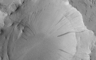 <h1>PIA04549:  Old Arabian Crater</h1><div class="PIA04549" lang="en" style="width:540px;text-align:left;margin:auto;background-color:#000;padding:10px;max-height:150px;overflow:auto;">MGS MOC Release No. MOC2-376, 30 May 2003<p>This Mars Global Surveyor (MGS) Mars Orbiter Camera (MOC) image shows an old meteor impact crater that was once buried and was then partially-exhumed from within the layered rocks on the floor of a much larger crater in eastern Arabia Terra. The erosion processes that began to exhume the crater, however, stopped some time ago, because today the entire area is covered by a blanket of dust. Avalanches of this dust have created dark streaks on the walls of the partly exhumed crater. This April 2003 image covers an area 3 km (1.9 mi) wide and is located near 20.9°N, 320.8°W. Sunlight illuminates the scene from the lower left.<p><br /><br /><a href="http://photojournal.jpl.nasa.gov/catalog/PIA04549" onclick="window.open(this.href); return false;" title="Voir l'image 	 PIA04549:  Old Arabian Crater	  sur le site de la NASA">Voir l'image 	 PIA04549:  Old Arabian Crater	  sur le site de la NASA.</a></div>