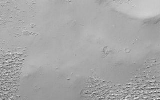 <h1>PIA04551:  Apollinaris Patera Surfaces</h1><div class="PIA04551" lang="en" style="width:540px;text-align:left;margin:auto;background-color:#000;padding:10px;max-height:150px;overflow:auto;">MGS MOC Release No. MOC2-378, 1 June 2003<p>This Mars Global Surveyor (MGS) Mars Orbiter Camera (MOC) image shows rugged, wind-eroded material that once used to completely cover the upper flanks of the martian volcano, Apollinaris Patera. This material; perhaps ancient volcanic ash or more recent, cemented dust, has been partially removed by wind erosion, revealing a smoother surface beneath. This view is located near the summit of the volcano, around 9.3°S, 186.1°W. Sunlight illuminates the scene from the upper left.<p><br /><br /><a href="http://photojournal.jpl.nasa.gov/catalog/PIA04551" onclick="window.open(this.href); return false;" title="Voir l'image 	 PIA04551:  Apollinaris Patera Surfaces	  sur le site de la NASA">Voir l'image 	 PIA04551:  Apollinaris Patera Surfaces	  sur le site de la NASA.</a></div>