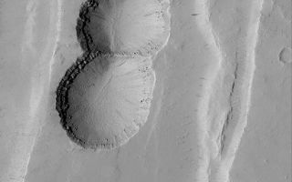 <h1>PIA04568:  Tractus Catena Collapse Pits</h1><div class="PIA04568" lang="en" style="width:540px;text-align:left;margin:auto;background-color:#000;padding:10px;max-height:150px;overflow:auto;">MGS MOC Release No. MOC2-386, 9 June 2003<p>This chain of pits formed by collapse as faulting extended the upper crust in the Tractus Catena region of Mars. The layered bedrock can be seen in the upper walls of each pit in this Mars Global Surveyor (MGS) Mars Orbiter Camera (MOC) image. The picture covers an area about 3 km (1.9 mi) wide near 28.5°N, 102.9°W. Sunlight illuminates the scene from the left.<p><br /><br /><a href="http://photojournal.jpl.nasa.gov/catalog/PIA04568" onclick="window.open(this.href); return false;" title="Voir l'image 	 PIA04568:  Tractus Catena Collapse Pits	  sur le site de la NASA">Voir l'image 	 PIA04568:  Tractus Catena Collapse Pits	  sur le site de la NASA.</a></div>