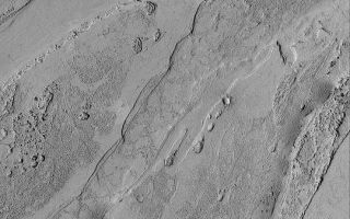 <h1>PIA04614:  Valley South of Cerberus</h1><div class="PIA04614" lang="en" style="width:540px;text-align:left;margin:auto;background-color:#000;padding:10px;max-height:150px;overflow:auto;">MGS MOC Release No. MOC2-413, 6 July 2003<p>To date, the Mars Global Surveyor (MGS) Mars Orbiter Camera (MOC) narrow angle system has only imaged about 3% of the martian surface. Thus, a new discovery can come at any time, as additional places are covered every day. This MOC image shows a portion of a shallow valley south of Cerberus that was just discovered in April 2003. The valley may have been cut but torrents of mud-laden water; alternatively, an extremely fluid lava was involved. This picture was acquired in May 2003; it covers an area 3 km (1.9 mi) wide and is illuminated from the left. North is toward the top/upper right. The picture is located near 4.6°N, 204.3°W.<p><br /><br /><a href="http://photojournal.jpl.nasa.gov/catalog/PIA04614" onclick="window.open(this.href); return false;" title="Voir l'image 	 PIA04614:  Valley South of Cerberus	  sur le site de la NASA">Voir l'image 	 PIA04614:  Valley South of Cerberus	  sur le site de la NASA.</a></div>