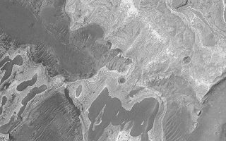 <h1>PIA04637:  Sedimentary Rock Near Coprates</h1><div class="PIA04637" lang="en" style="width:540px;text-align:left;margin:auto;background-color:#000;padding:10px;max-height:150px;overflow:auto;">MGS MOC Release No. MOC2-420, 13 July 2003<p>This mosaic of two Mars Global Surveyor (MGS) Mars Orbiter Camera (MOC) narrow angle camera images, one from 2001, the other from 2003, shows light-toned, layered, sedimentary rock outcrops exposed on the floor of a trough that parallels Coprates Chasma in the Valles Marineris system. Layered rocks form the pages from which the history of a place can be read. It may be many years before the story is read, but or now at least we know where one of the books of martian history is found. This picture is located near 15.2°S, 60.1°W. Sunlight illuminates the scene from the left.<p><br /><br /><a href="http://photojournal.jpl.nasa.gov/catalog/PIA04637" onclick="window.open(this.href); return false;" title="Voir l'image 	 PIA04637:  Sedimentary Rock Near Coprates	  sur le site de la NASA">Voir l'image 	 PIA04637:  Sedimentary Rock Near Coprates	  sur le site de la NASA.</a></div>