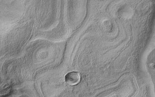 <h1>PIA04694:  Banded Terrain in East Hellas</h1><div class="PIA04694" lang="en" style="width:800px;text-align:left;margin:auto;background-color:#000;padding:10px;max-height:150px;overflow:auto;">MGS MOC Release No. MOC2-460, 22 August 2003<p />This Mars Global Surveyor (MGS) Mars Orbiter Camera (MOC) narrow angle camera image shows banded terrain in easternmost Hellas Planitia, between the distal ends of Dao and Harmakhis valleys. These bands probably indicate the location of eroded, layered bedrock that has been covered by a mantling deposit that, itself, became eroded to form the very small pits and bumps that pervade the region. This picture is located near 41.1°S, 275.0°W. Sunlight illuminates the scene from the left/upper left.<br /><br /><a href="http://photojournal.jpl.nasa.gov/catalog/PIA04694" onclick="window.open(this.href); return false;" title="Voir l'image 	 PIA04694:  Banded Terrain in East Hellas	  sur le site de la NASA">Voir l'image 	 PIA04694:  Banded Terrain in East Hellas	  sur le site de la NASA.</a></div>