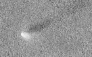 <h1>PIA04698:  Summertime Dust Devil</h1><div class="PIA04698" lang="en" style="width:600px;text-align:left;margin:auto;background-color:#000;padding:10px;max-height:150px;overflow:auto;">MGS MOC Release No. MOC2-464, 26 August 2003<p />Dust devils are spinning, columnar vortices of air that move across a landscape, picking up dust as they go. They are common occurrences during summer on Mars. This Mars Global Surveyor (MGS) Mars Orbiter Camera (MOC) image, acquired during northern summer, shows a dust devil in the Phlegra region of Mars near 32.0°N, 182.1°W. Sunlight illuminates the scene from the lower left; the dust devil is casting a columnar shadow toward the upper right. Some dust devils on Mars make streaks as they disrupt the fine coating of dust on the surface--but others do not make streaks. This one did not make a streak. The view shown here is 3 km (1.9 mi) wide.<br /><br /><a href="http://photojournal.jpl.nasa.gov/catalog/PIA04698" onclick="window.open(this.href); return false;" title="Voir l'image 	 PIA04698:  Summertime Dust Devil	  sur le site de la NASA">Voir l'image 	 PIA04698:  Summertime Dust Devil	  sur le site de la NASA.</a></div>