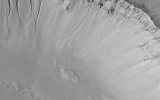 <h1>PIA04722:  Martian Gullies</h1><div class="PIA04722" lang="en" style="width:799px;text-align:left;margin:auto;background-color:#000;padding:10px;max-height:150px;overflow:auto;">MGS MOC Release No. MOC2-470, 1 September 2003<p />This July 2003 Mars Global Surveyor (MGS) Mars Orbiter Camera (MOC) full-resolution (1.5 meters--5 feet--per pixel) image shows a suite of gullies in the wall of a crater near 35.3°S, 76.3°W. The gullies are considered to have formed by downslope transport of water-laden debris, although the exact nature of the fluid is unknown because it is no longer present. This image covers an area 3 km (1.9 mi) wide. Sunlight illuminates the scene from the upper left.<br /><br /><a href="http://photojournal.jpl.nasa.gov/catalog/PIA04722" onclick="window.open(this.href); return false;" title="Voir l'image 	 PIA04722:  Martian Gullies	  sur le site de la NASA">Voir l'image 	 PIA04722:  Martian Gullies	  sur le site de la NASA.</a></div>