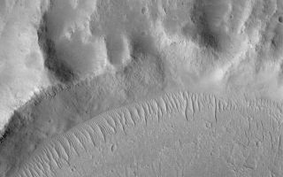 <h1>PIA04744:  Kasei Valles Scene</h1><div class="PIA04744" lang="en" style="width:799px;text-align:left;margin:auto;background-color:#000;padding:10px;max-height:150px;overflow:auto;">MGS MOC Release No. MOC2-483, 14 September 2003<p />This is a May 2003 Mars Global Surveyor (MGS) Mars Orbiter Camera (MOC) picture of terrain in the Kasei Valles region. The lower third of the image shows flow patterns formed by mud or lava from some of the youngest flow events that occurred in the valley system. These events occurred some time ago, however, because there has been sufficient time for a plethora of small impact craters to form on the surface. In addition, large, ripple-like, windblown bedforms occur along the margin of the flow materials and the adjacent upland. At least two generations of ripples are recognized--a suite of larger ones with groups of smaller ripples located between them. The image is located near 16.4°N, 74.9°W. This picture covers an area 3 km (1.9 mi) across and is illuminated by sunlight from the lower left.<br /><br /><a href="http://photojournal.jpl.nasa.gov/catalog/PIA04744" onclick="window.open(this.href); return false;" title="Voir l'image 	 PIA04744:  Kasei Valles Scene	  sur le site de la NASA">Voir l'image 	 PIA04744:  Kasei Valles Scene	  sur le site de la NASA.</a></div>