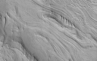 <h1>PIA04785:  East Candor Layers</h1><div class="PIA04785" lang="en" style="width:672px;text-align:left;margin:auto;background-color:#000;padding:10px;max-height:150px;overflow:auto;">MGS MOC Release No. MOC2-507, 8 October 2003<p />The Mars Global Surveyor (MGS) Mars Orbiter Camera (MOC) experiment was designed to study the geology and geomorphology of Mars by providing images comparable in resolution to the aerial photographs used by terrestrial geologists in conducting their field work. For over six years, the MOC narrow angle camera has been returning pictures that underscore, time and again, the layered nature of the upper martian crust. It is from layered rock that geologists will one day be able to decipher the history of the red planet. This example of layered rock exposures occurs in eastern Candor Chasma, one of the troughs of the Valles Marineris system. The picture is located near 8.0°S, 67.0°W, and covers an area 3 km (1.9 mi) wide. The image is illuminated by sunlight from the lower left.<br /><br /><a href="http://photojournal.jpl.nasa.gov/catalog/PIA04785" onclick="window.open(this.href); return false;" title="Voir l'image 	 PIA04785:  East Candor Layers	  sur le site de la NASA">Voir l'image 	 PIA04785:  East Candor Layers	  sur le site de la NASA.</a></div>